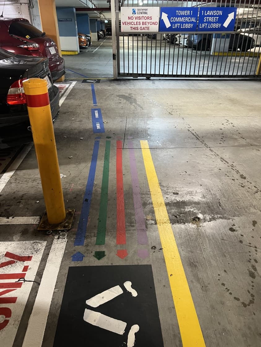Coloured floor lines leading to the Tower 1 lift lobby inside the Southport Central carpark